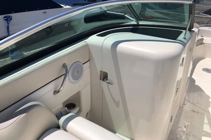 Slide: The Image of 2013 Sea Ray 260 Sundeck interior with white seating and speaker detail. - 12