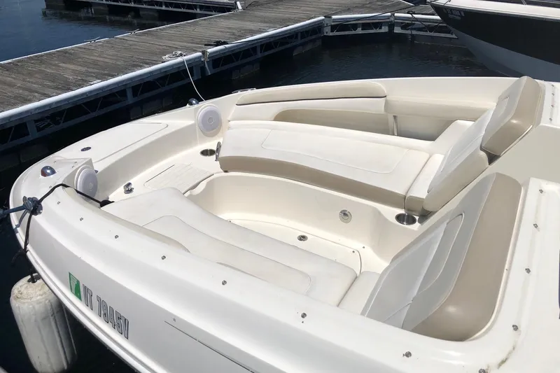 Slide: The Image of 2013 Sea Ray 260 Sundeck boat docked, featuring spacious seating and sleek design. - 2