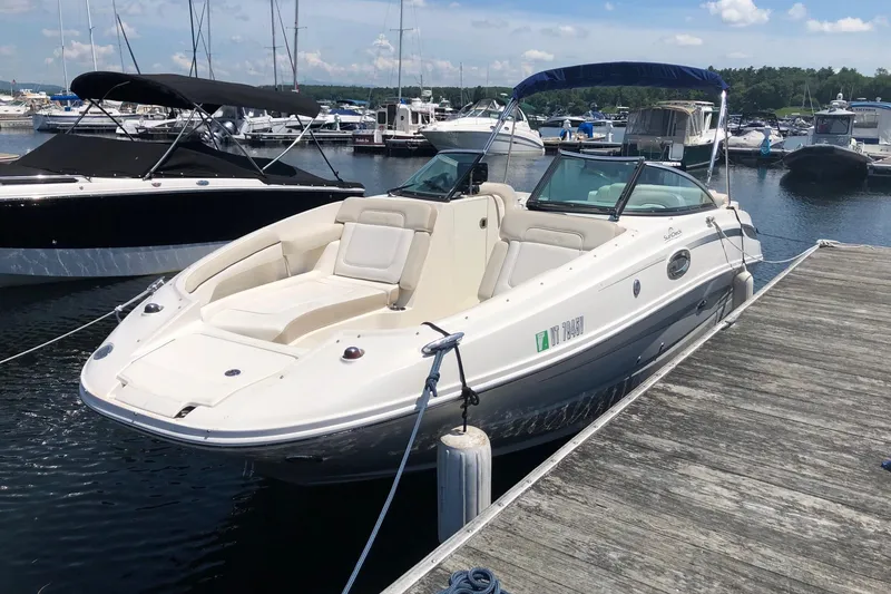 Slide: The Image of 2013 Sea Ray 260 Sundeck boat docked at a marina on a sunny day. - 3
