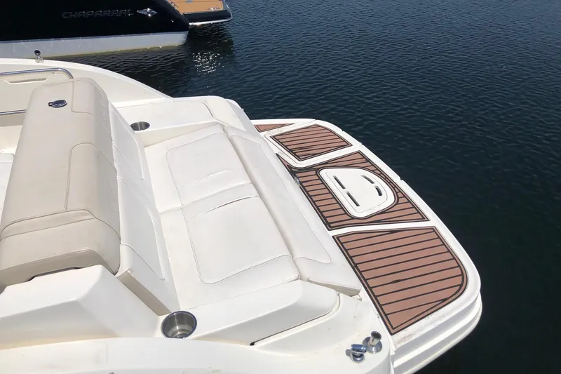 Slide: The Image of 2013 Sea Ray 260 Sundeck boat with spacious seating and swim platform on calm water. - 6