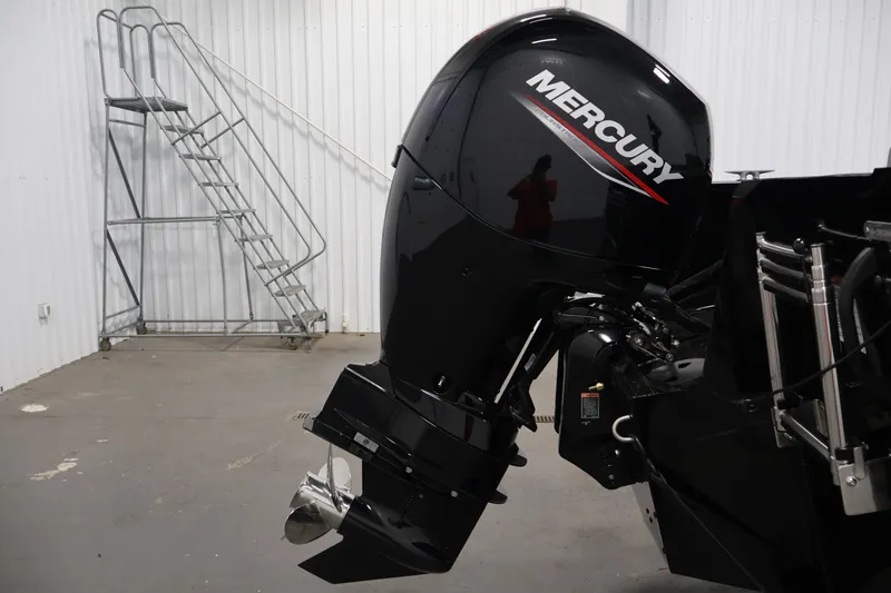 Slide: The Image of 2026 Crestliner 1850 Commander with Mercury outboard motor in a garage setting. - 31