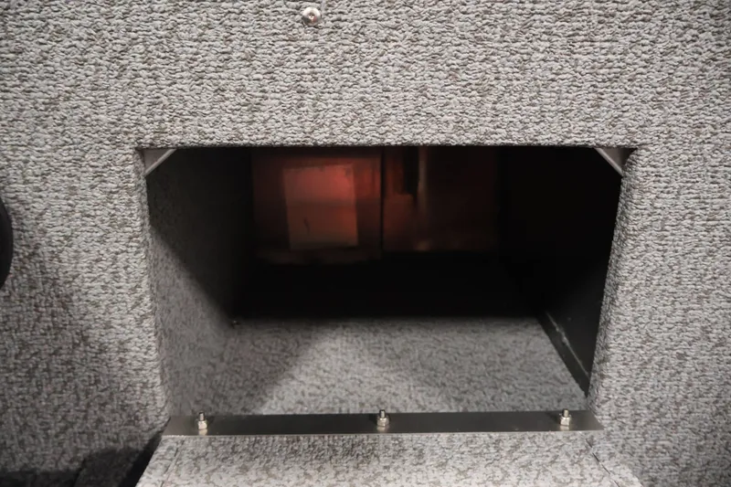 Slide: The Image of Interior compartment of 2026 Crestliner 1850 Commander boat, featuring carpeted storage space. - 29