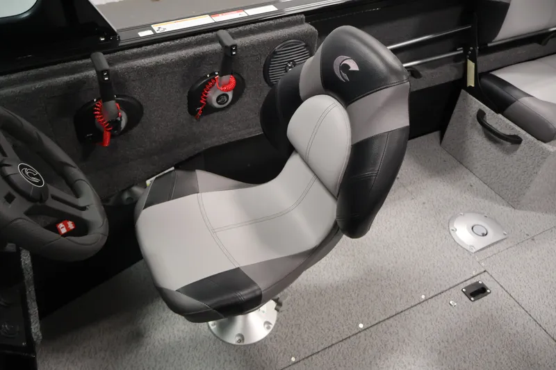 Slide: The Image of 2026 Crestliner 1850 Commander interior with ergonomic captain's chair and steering wheel. - 19