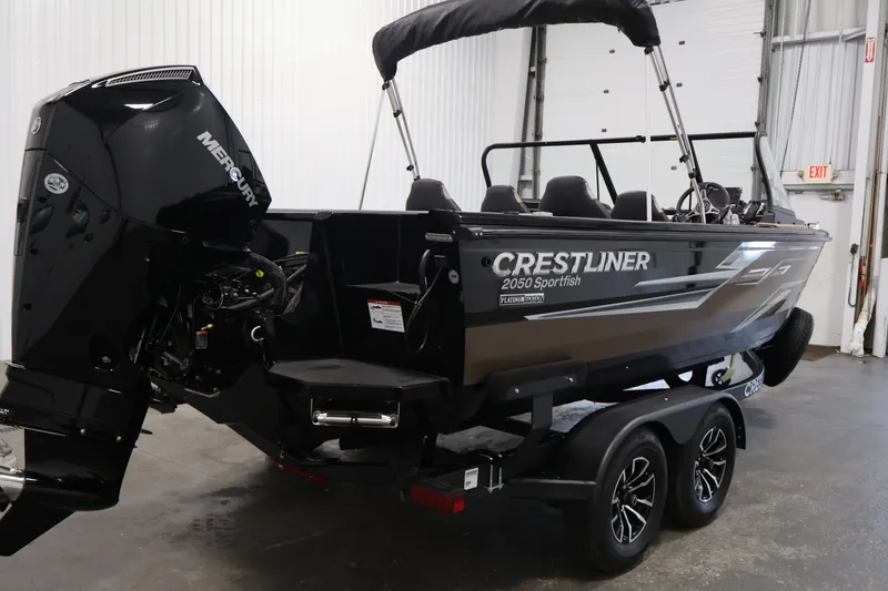 Slide: The Image of 2026 Crestliner 2050 Sportfish boat with Mercury engine in indoor setting. - 4