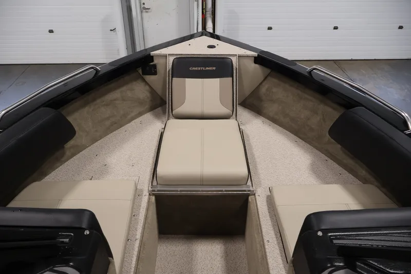 Slide: The Image of 2026 Crestliner 2050 Sportfish boat interior with beige seating and black accents. - 10