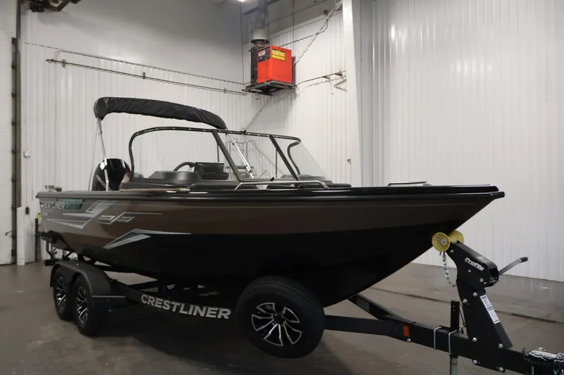 Slide: The Image of 2026 Crestliner 2050 Sportfish boat on trailer in indoor storage facility. - 2