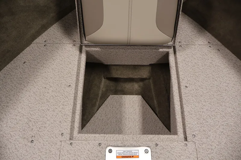 Slide: The Image of 2026 Crestliner 2050 Sportfish boat interior storage compartment, featuring durable carpeted flooring. - 11