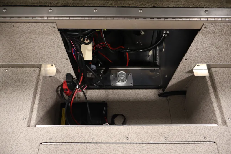 Slide: The Image of Interior view of 2026 Crestliner 2050 Sportfish boat wiring and battery compartment. - 32