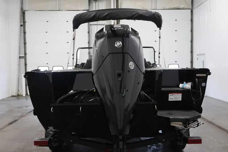 Slide: The Image of 2026 Crestliner 2050 Sportfish boat in a garage, rear view with outboard motor. - 5