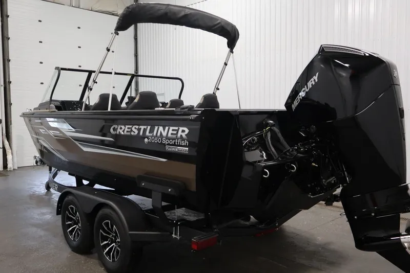 Slide: The Image of 2026 Crestliner 2050 Sportfish boat with Mercury engine in indoor setting. - 9
