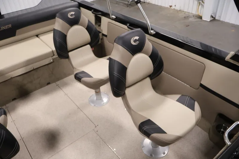 Slide: The Image of 2026 Crestliner 2050 Sportfish interior with two cushioned seats and beige flooring. - 22