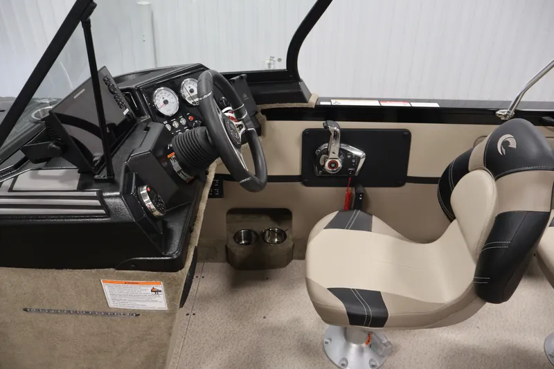 Slide: The Image of 2026 Crestliner 2050 Sportfish boat interior with steering console and cushioned seat. - 16