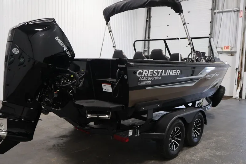 Slide: The Image of 2026 Crestliner 2050 Sportfish boat with Mercury engine in indoor setting. - 3