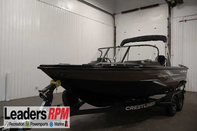 The Image of 2026 Crestliner 2050 Sportfish boat on trailer in indoor showroom. - 0