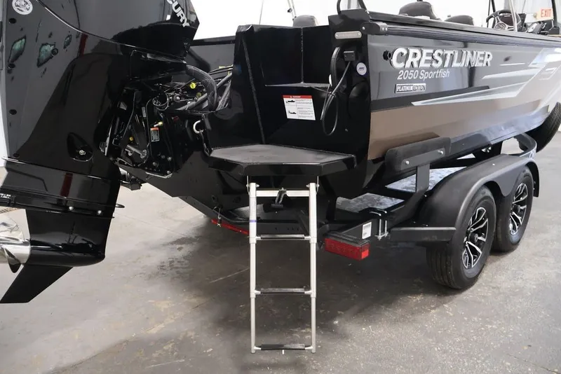 Slide: The Image of 2026 Crestliner 2050 Sportfish boat on trailer with ladder and outboard motor. - 49