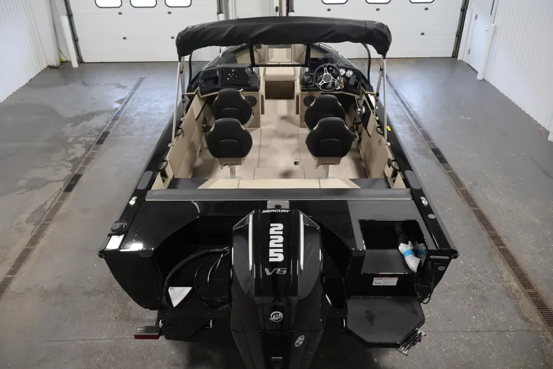 Slide: The Image of 2026 Crestliner 2050 Sportfish boat with Mercury V6 engine in a garage setting. - 9