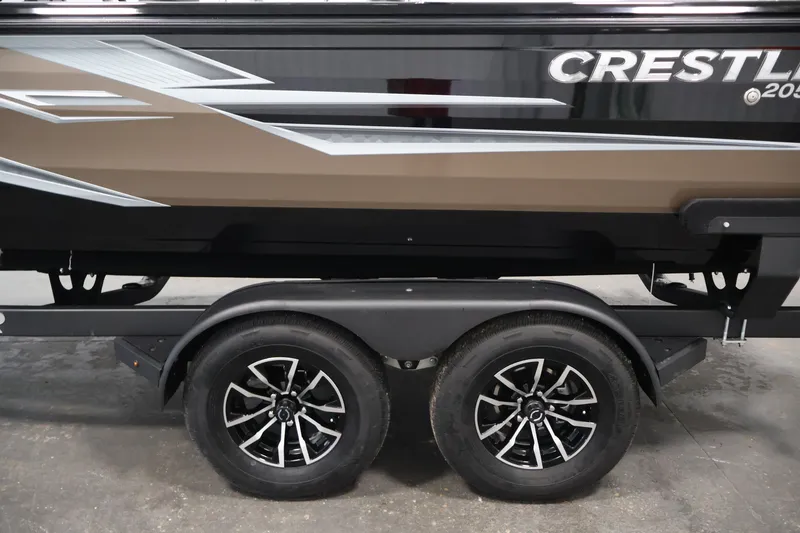 Slide: The Image of 2026 Crestliner 2050 Sportfish boat on trailer, showcasing sleek design and dual wheels. - 41