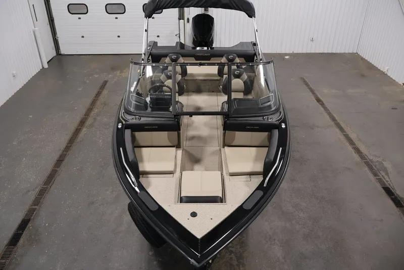 Slide: The Image of 2026 Crestliner 2050 Sportfish boat in a garage, showcasing seating and windshield. - 8