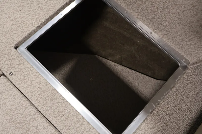 Slide: The Image of 2026 Crestliner 2050 Sportfish boat storage compartment with carpeted interior. - 15