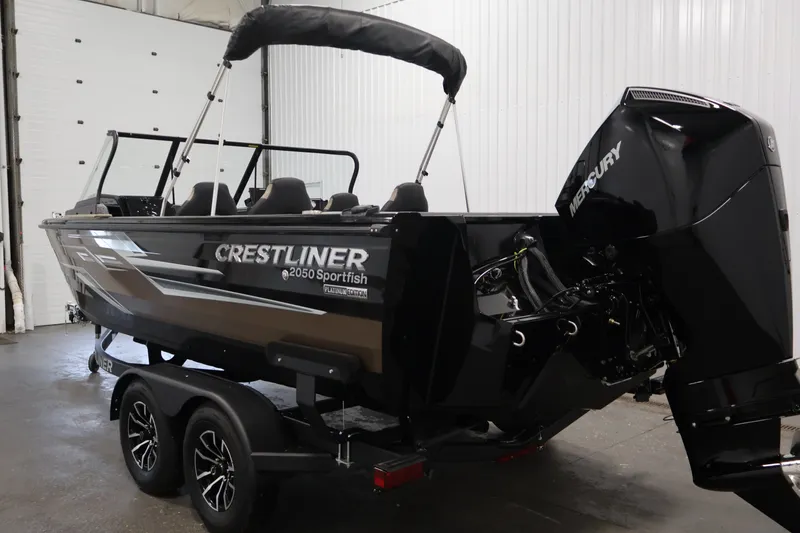 Slide: The Image of 2026 Crestliner 2050 Sportfish boat with Mercury engine in indoor setting. - 6