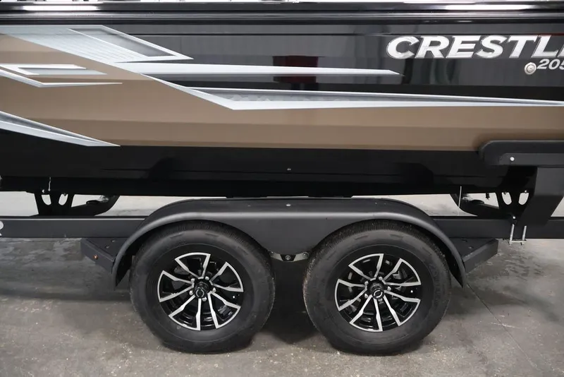 Slide: The Image of 2026 Crestliner 2050 Sportfish boat on trailer, featuring sleek design and dual wheels. - 36