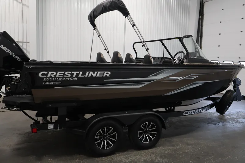 Slide: The Image of 2026 Crestliner 2050 Sportfish boat in a garage, featuring sleek design and Mercury engine. - 3