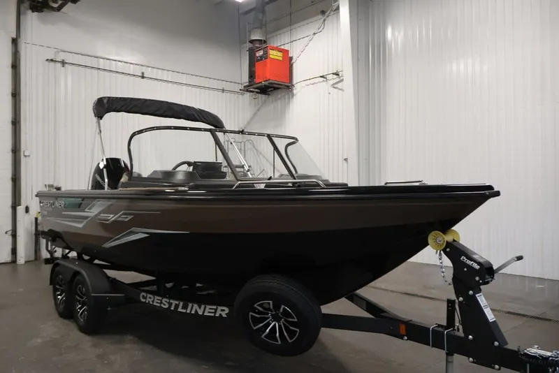 Slide: The Image of 2026 Crestliner 2050 Sportfish boat on trailer in indoor storage facility. - 2
