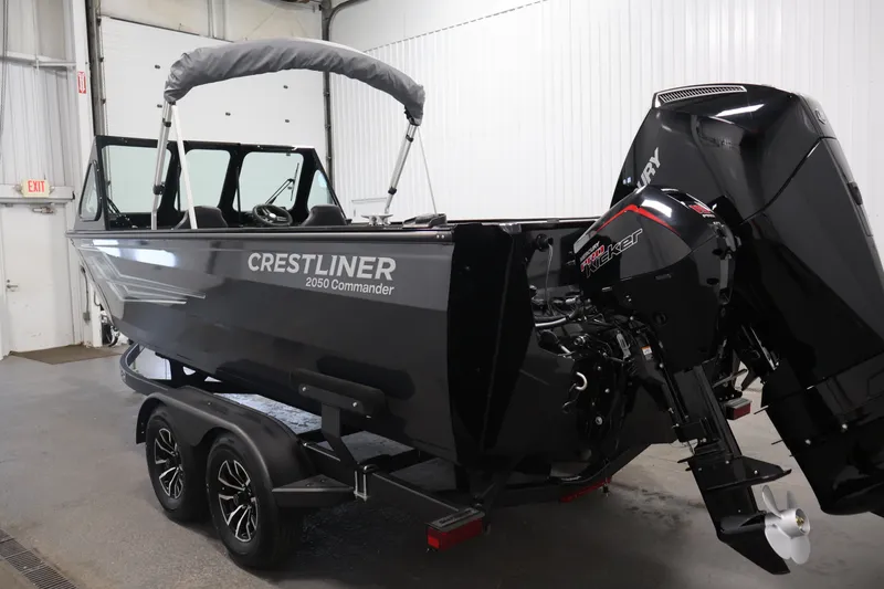 Slide: The Image of 2026 Crestliner 2050 Commander boat in a garage, featuring dual motors and sleek design. - 6