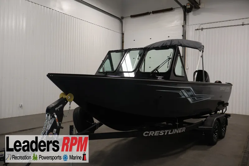 The Image of 2026 Crestliner 2050 Commander boat on trailer in indoor showroom. - 0