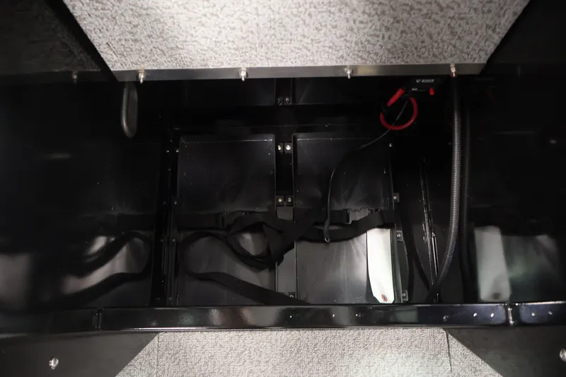 Slide: The Image of Battery compartment of 2026 Crestliner 2050 Commander boat, featuring secure straps and wiring. - 11