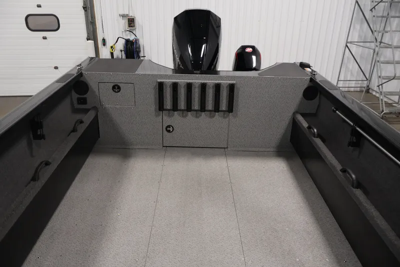 Slide: The Image of Interior view of 2026 Crestliner 2050 Commander boat, showcasing spacious deck and storage compartments. - 23
