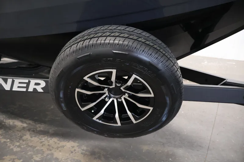 Slide: The Image of Trailer wheel of 2026 Crestliner 2050 Commander boat, featuring sleek black alloy rims. - 36