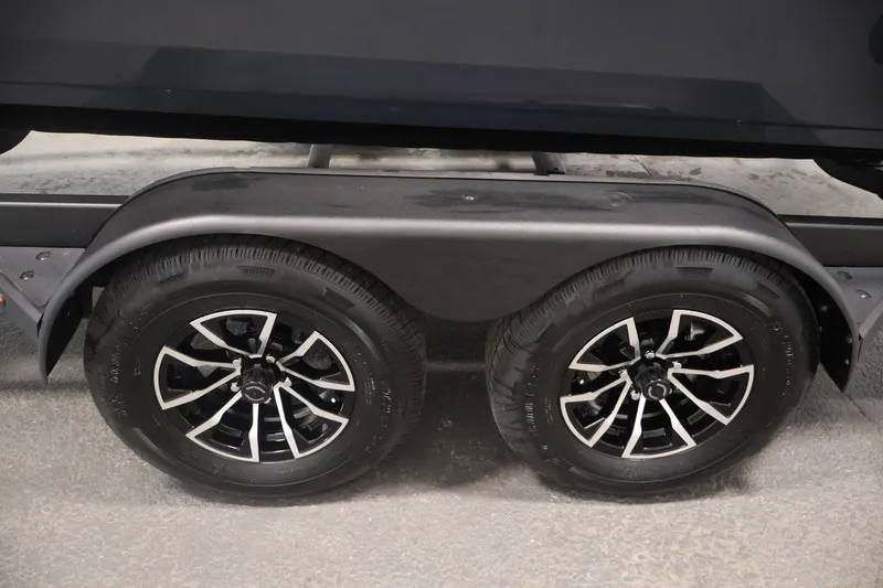 Slide: The Image of Trailer wheels of 2026 Crestliner 2050 Commander boat, featuring sleek black rims. - 38