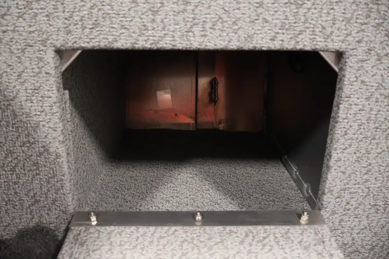 Slide: The Image of Interior storage compartment of 2026 Crestliner 2050 Commander boat, featuring carpeted finish. - 26