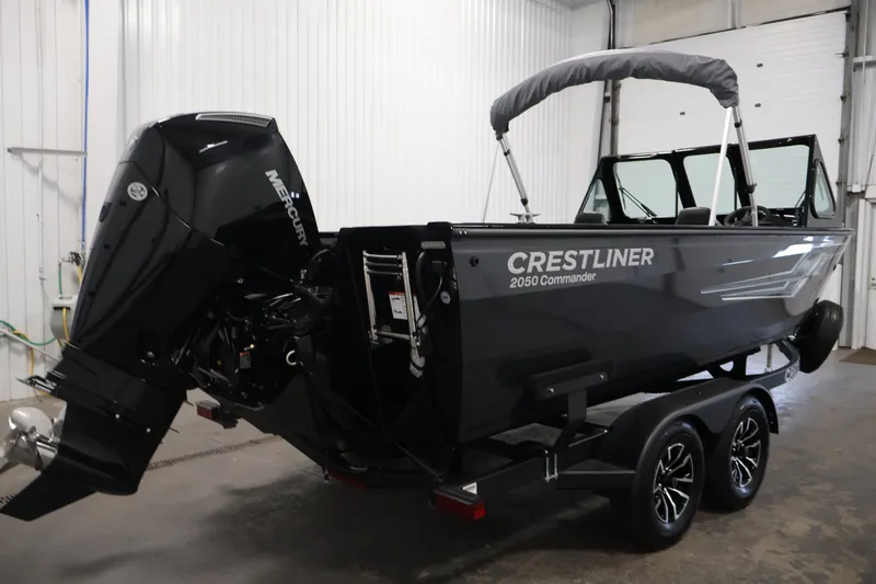 Slide: The Image of 2026 Crestliner 2050 Commander boat with Mercury engine on trailer in indoor setting. - 4