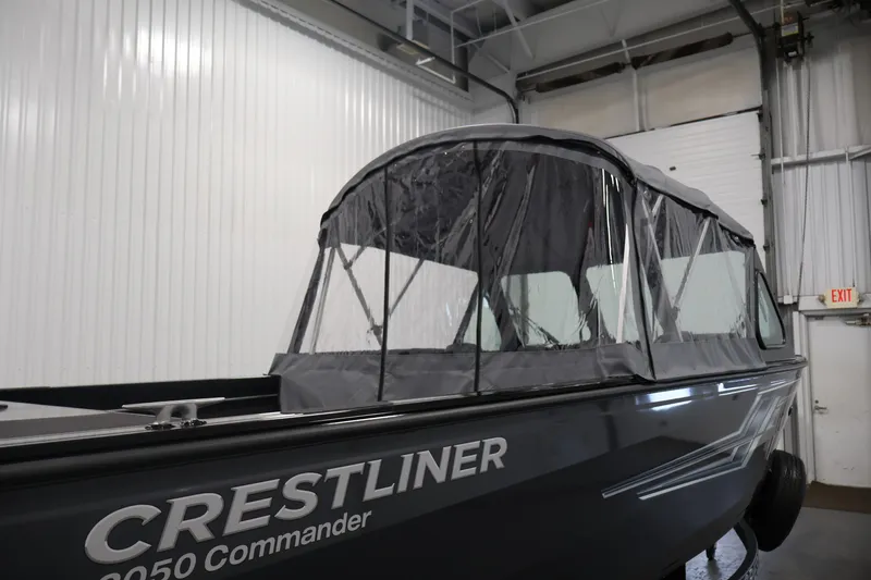 Slide: The Image of 2026 Crestliner 2050 Commander boat with canopy in a warehouse setting. - 41