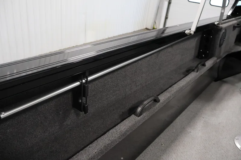 Slide: The Image of Interior view of 2026 Crestliner 2050 Commander boat, featuring sleek rail and storage area. - 24