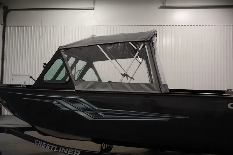 Slide: The Image of 2026 Crestliner 2050 Commander boat with canopy in indoor setting. - 39