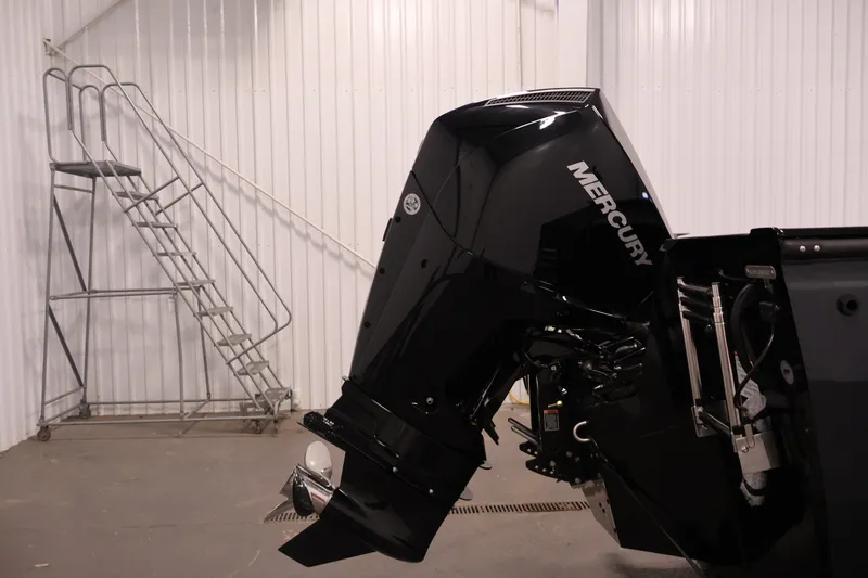 Slide: The Image of 2026 Crestliner 2050 Commander with Mercury outboard motor in a garage setting. - 29