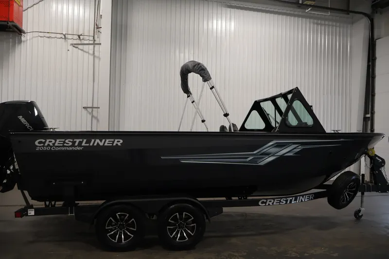 Slide: The Image of 2026 Crestliner 2050 Commander boat in a showroom, side view on trailer. - 3