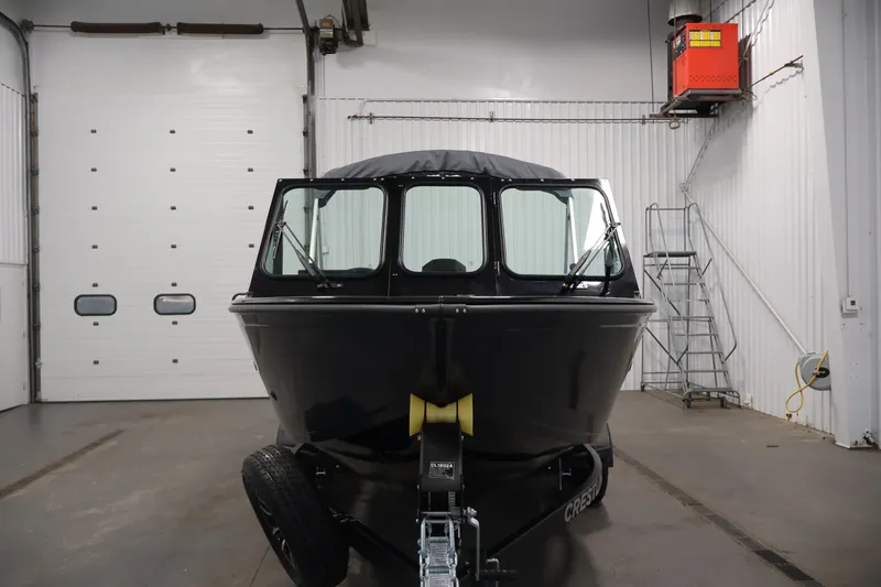 Slide: The Image of 2026 Crestliner 2050 Commander boat in indoor storage facility. - 1