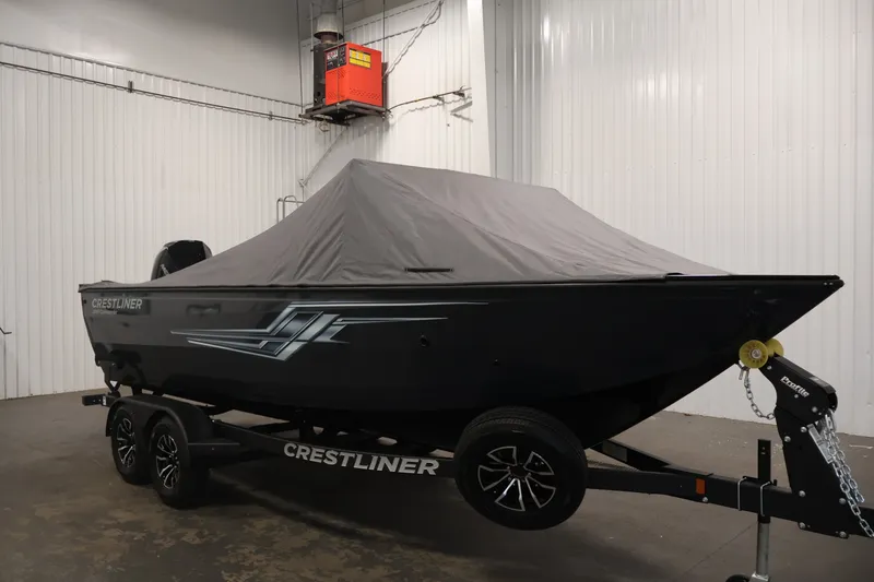 Slide: The Image of 2026 Crestliner 2050 Commander boat covered, on trailer in indoor storage. - 43