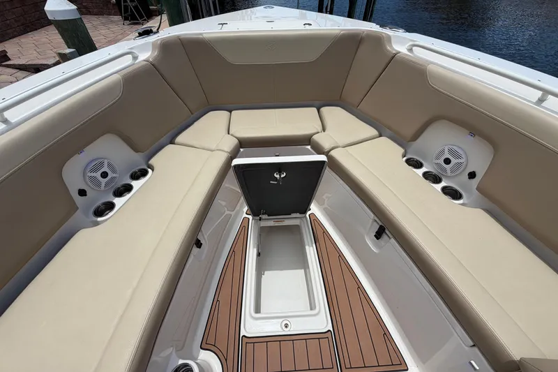 Slide: The Image of Spacious seating area on 2018 Sailfish 325 DC boat with storage and speakers. - 10