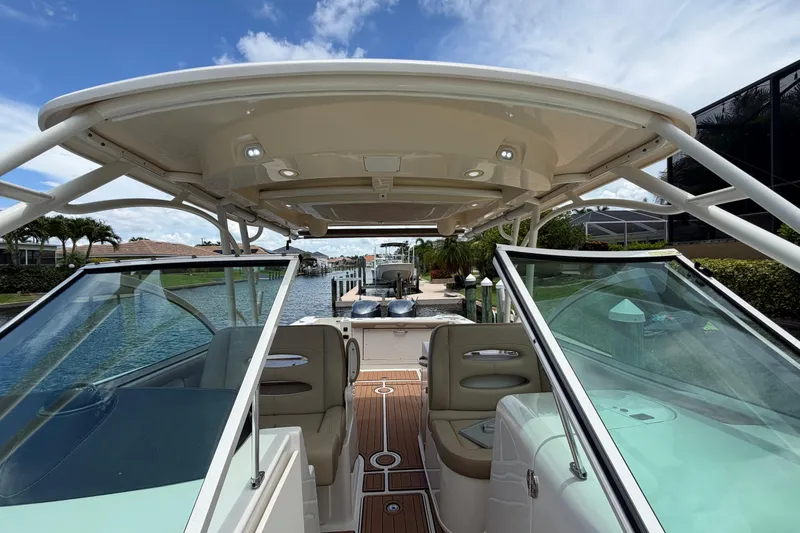Slide: The Image of 2018 Sailfish 325 DC boat docked, featuring spacious seating and sleek design. - 12