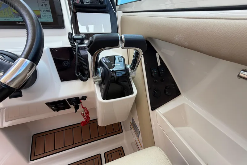 Slide: The Image of Helm of 2018 Sailfish 325 DC boat with steering wheel and controls. - 18