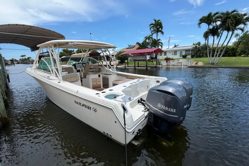 Slide: The Image of 2018 Sailfish 325 DC boat with Yamaha engines docked on a sunny day. - 2