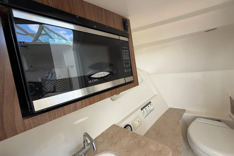 Slide: The Image of 2018 Sailfish 325 DC interior with microwave, sink, and toilet. - 26
