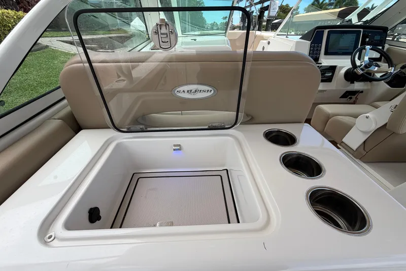 Slide: The Image of 2018 Sailfish 325 DC boat interior with storage compartment and cup holders. - 34