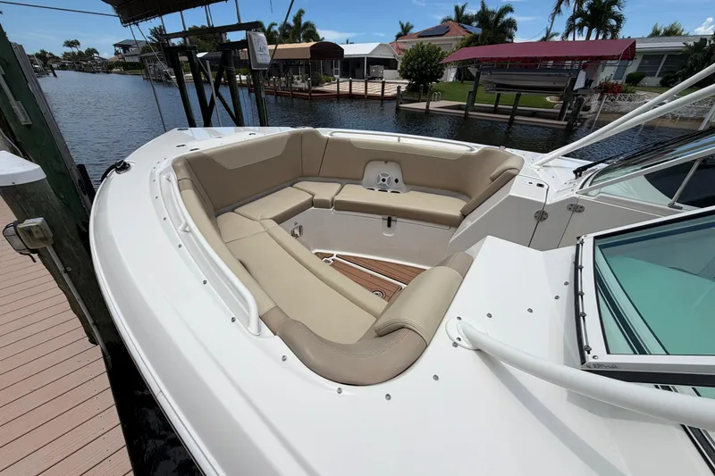 Slide: The Image of 2018 Sailfish 325 DC boat with spacious seating at a dockside location. - 4