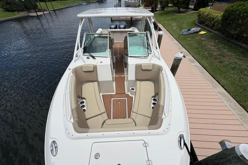 Slide: The Image of 2018 Sailfish 325 DC boat docked, featuring spacious seating and sleek design. - 6